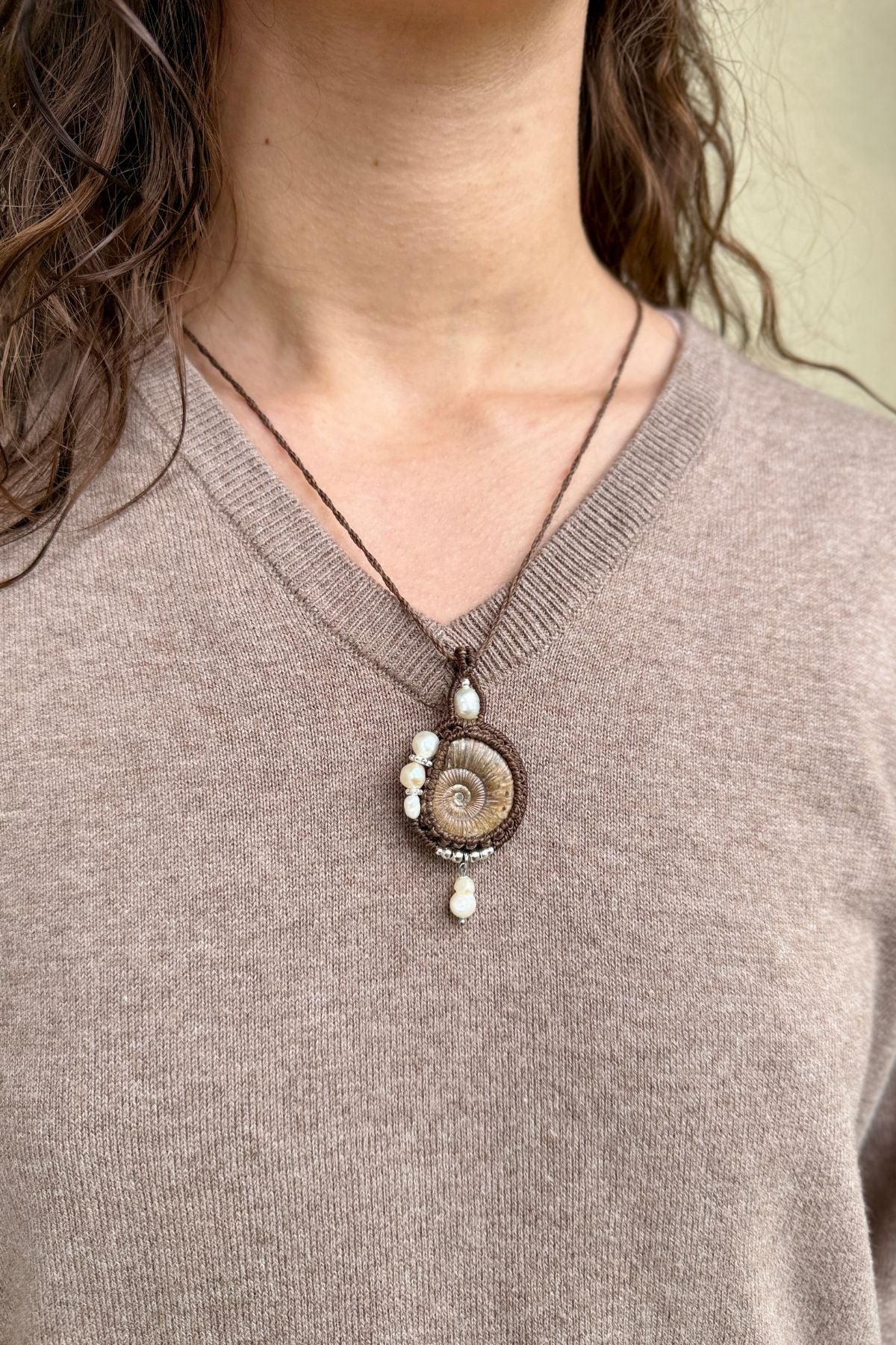 Model wearing rare ammonite and statement necklace, luxury ocean inspired jewelry