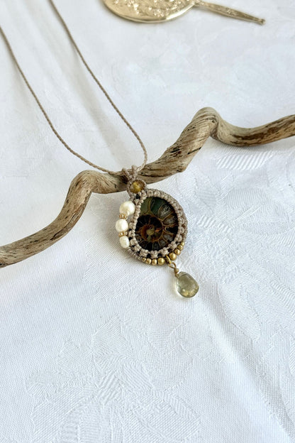 Close-up of Fresh Water pearls and Lemon Quartz accents on the ammonite fossil slice with natural veins and organic texture