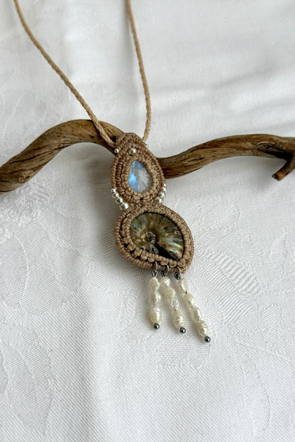 Close-up of opalized ammonite surface with natural iridescence, moonstone and freshwater pearls