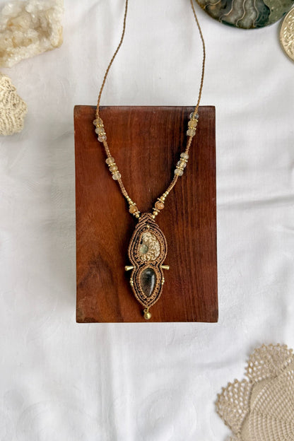 Natural ammonite fossil necklace with lodolite and faceted rutilated quartz along the strand, one of a kind