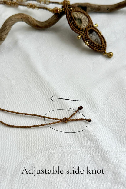 Adjustable sliding knot closure on ammonite and lodolite necklace with rutilated quartz details