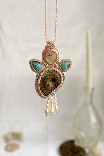 Opalized ammonite and larimar statement necklace hanging to showcase dangling freshwater pearl drops