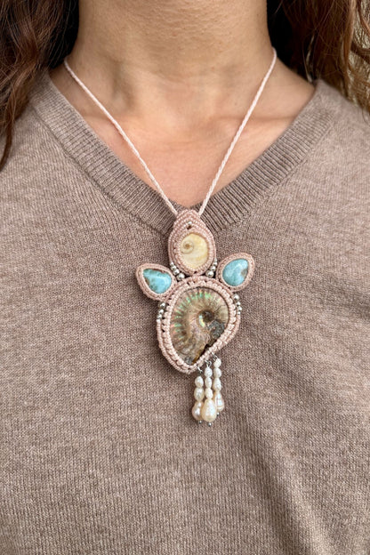 Model wearing opalized ammonite and larimar statement necklace, ocean inspired one of a kind jewelry