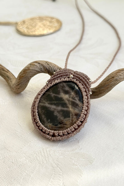 Side-angle view of the handmade macrame necklace with Black Moonstone. Showcasing depth, knotting details, and stone textures.