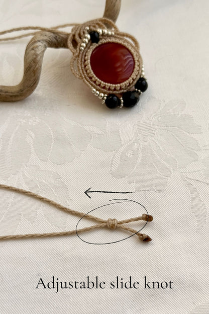 Adjustable handmade macrame necklace with Carnelian and Onyx. Featuring a sliding knot closure for a customizable fit.