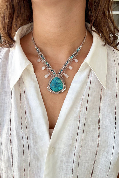 Model wearing a V-shaped Chrysocolla macramé statement necklace with Azurite and Moonstone accents
