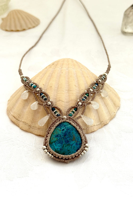 Close-up of a one of a kind Chrysocolla V-shaped macramé necklace showing deep blue gemstone patterns, Azurite beads, and silver details