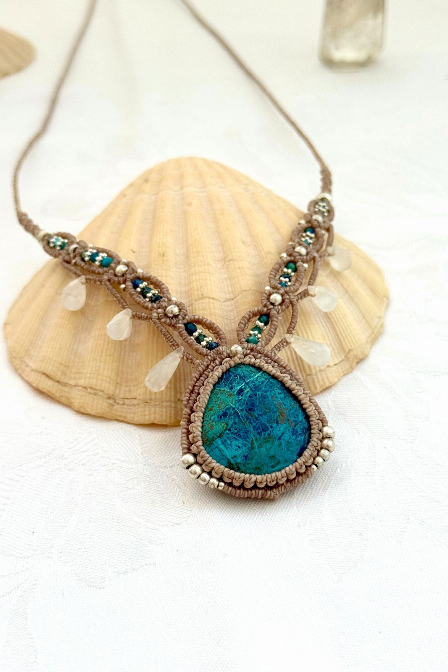 Close-up side view of a Chrysocolla macramé necklace highlighting Azurite beads, Moonstone drops, and intricate knotwork