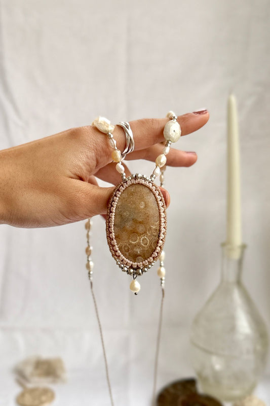 Fossil coral and Freshwater Pearl statement necklace shown in hand, unique ocean elegant jewelry.