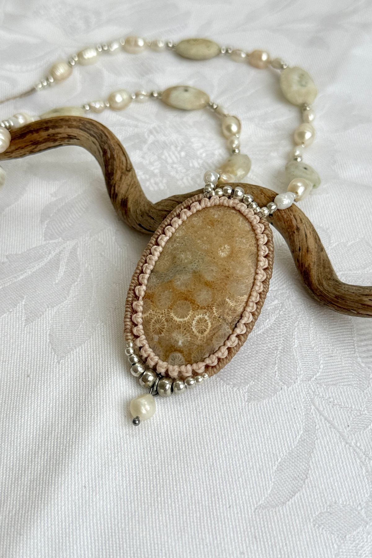Detailed view of fossil Coral necklace with organic textures and luxurious natural pearl design