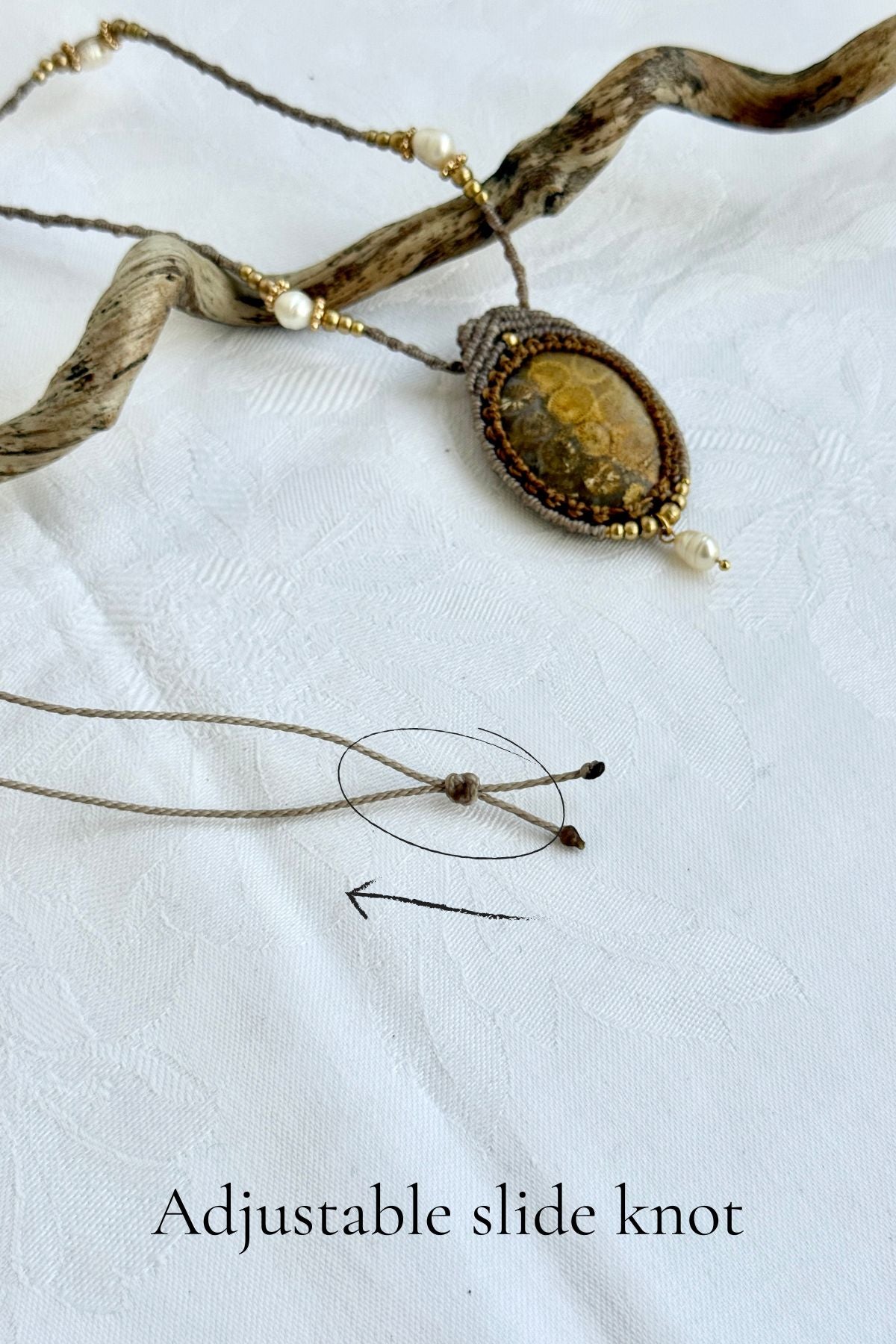 Detail of adjustable slide knot on fossil coral pendant necklace, allowing versatile fit from short to longer length