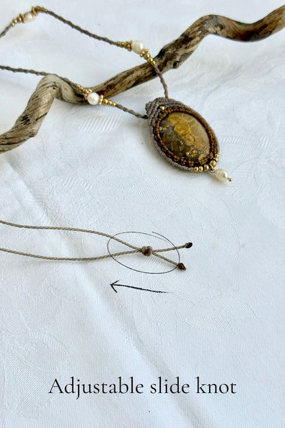 Detail of adjustable slide knot on fossil coral pendant necklace, allowing versatile fit from short to longer length
