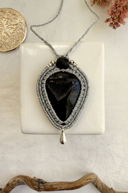 Handmade macrame necklace with Druzy Onyx gemstone, part of the Nocturnal Collection. One-of-a-kind design, laid flat for an artistic display.