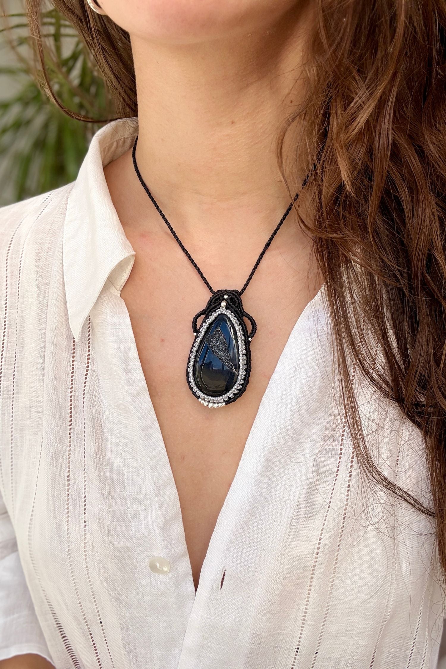 Druzy Onyx macrame necklace worn by a model. Showcasing the unique handmade design and how it looks when worn.