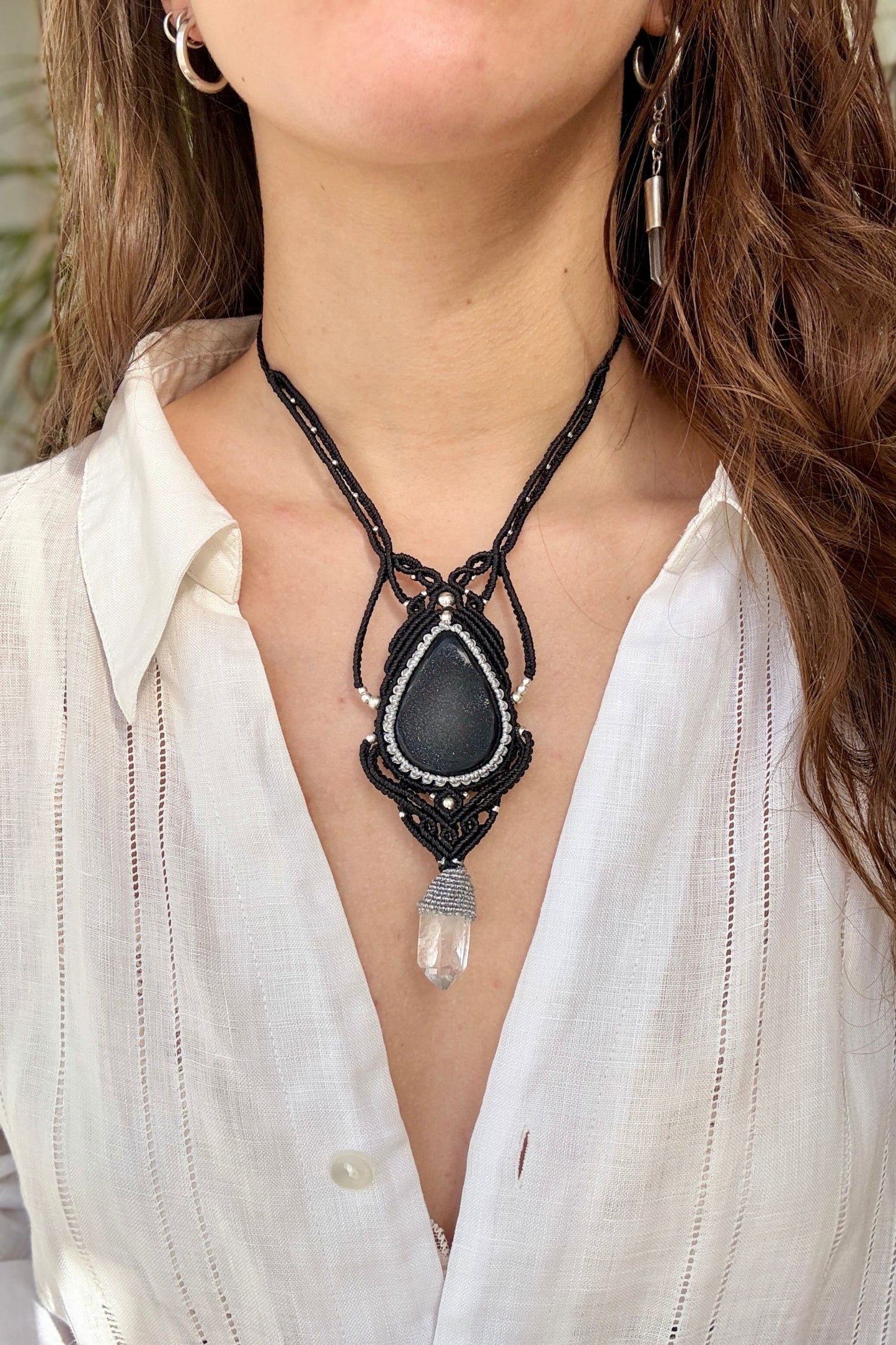 Druzy Onyx and Clear Quartz point macrame necklace worn by a model. Showcasing the unique handmade design and how it looks when worn.