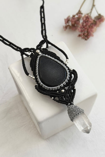 Detailed close-up of Druzy Onyx and Clear Quartz point gemstones in a handmade macrame necklace. Showcasing natural textures and gemstone glow.