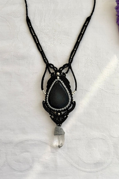 Close-up of the Druzy Onyx and Clear Quartz point macrame necklace in a unique setting. Highlighting the craftsmanship and gemstones details.