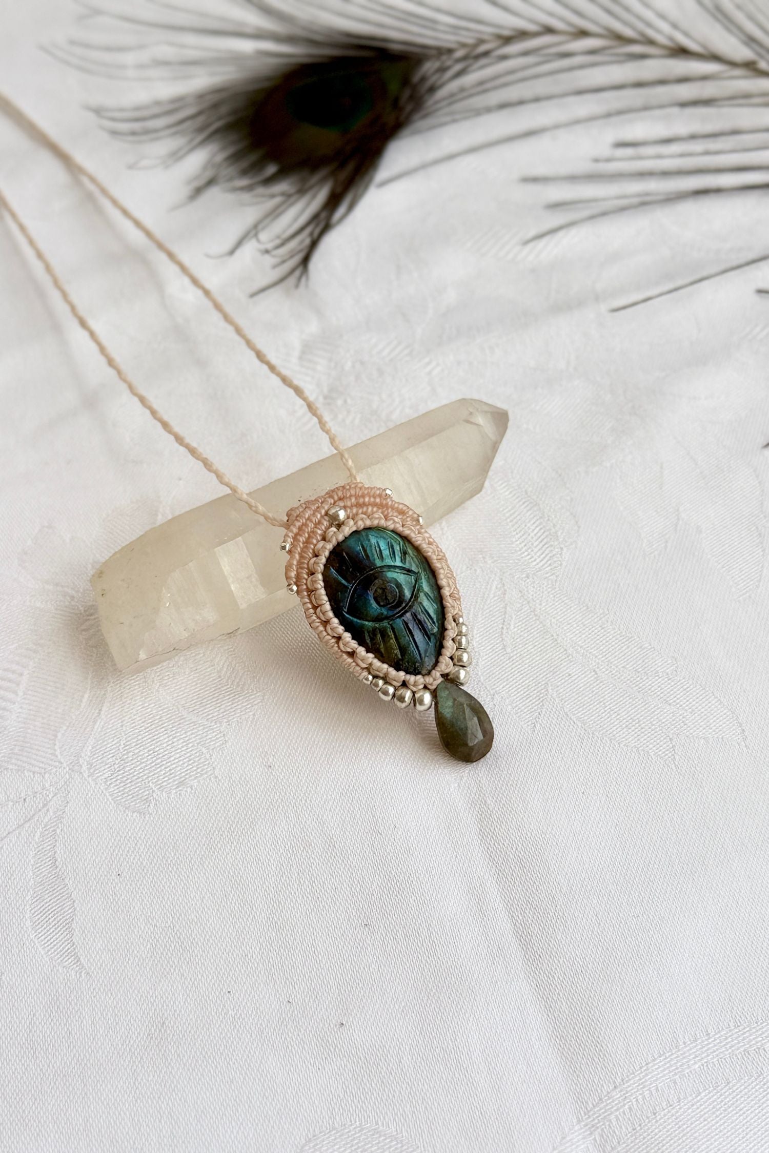 Artisan Labradorite protective eye necklace, shown from another angle to capture gemstone hues faceted dropping tear detail.
