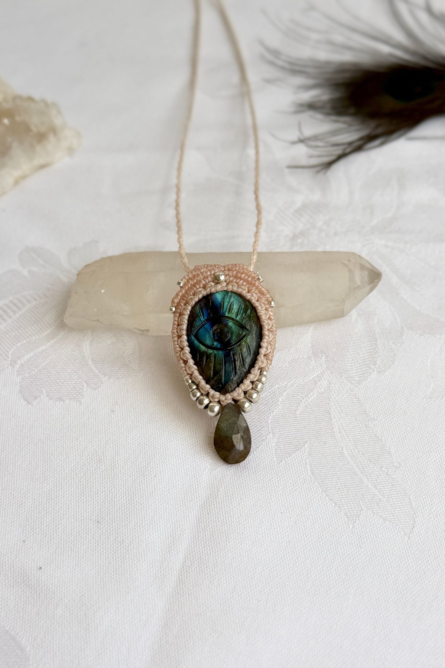 Handmade macrame necklace with Labradorite protective eye pendant, displayed flat to reveal gemstone’s natural labradorescence.