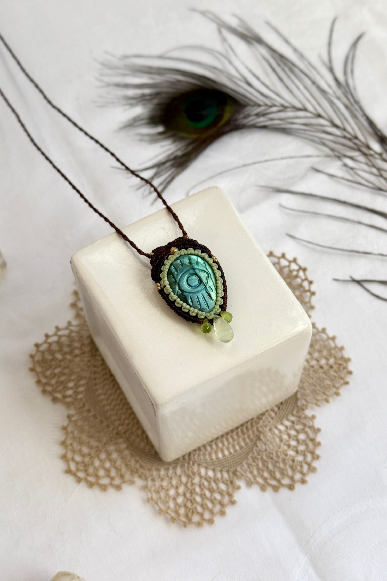 Handmade macrame necklace with Labradorite protective eye pendant, displayed flat to reveal gemstone’s natural labradorescence.
