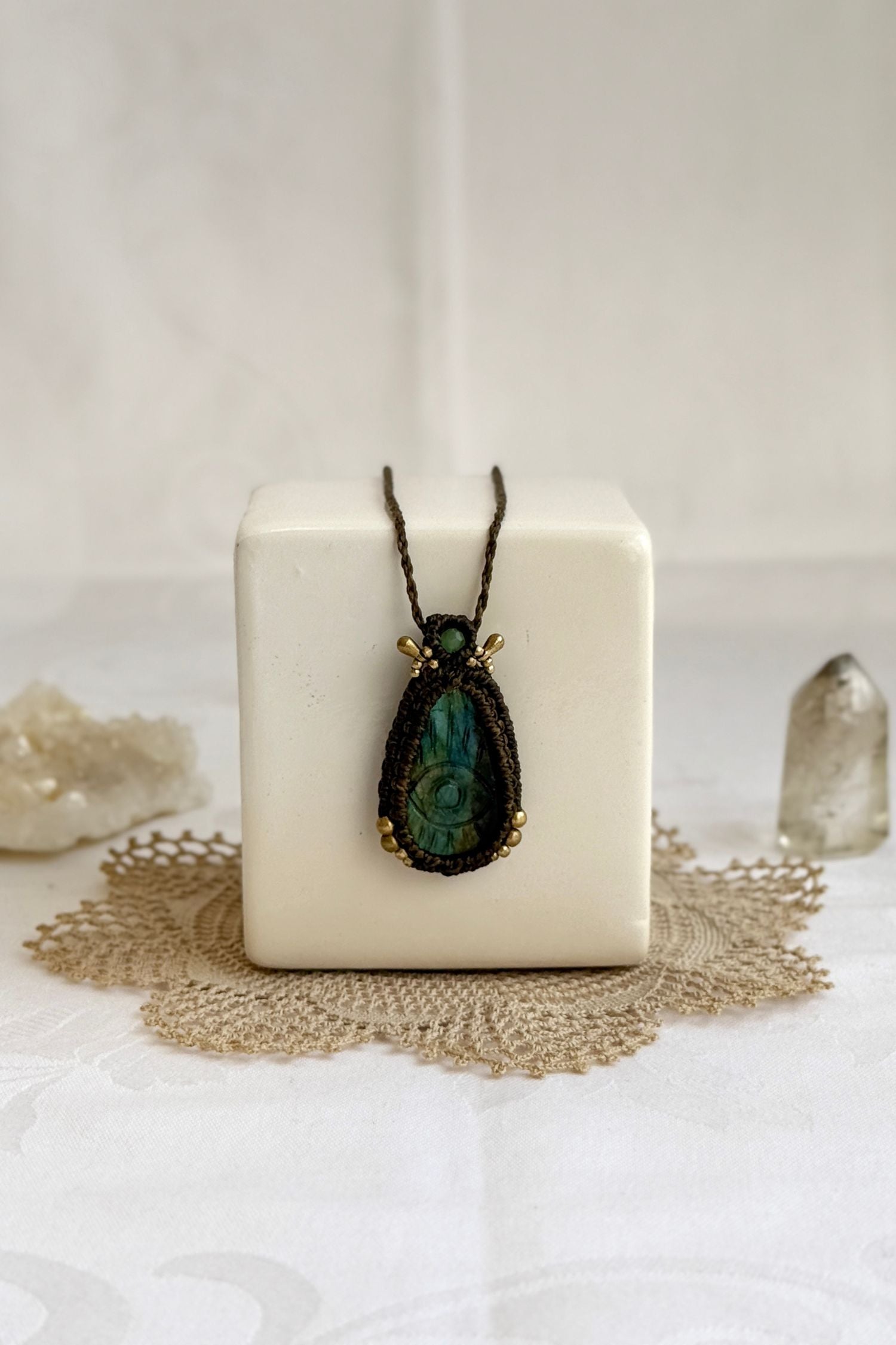 Artisan Labradorite protective eye necklace, shown from another angle to capture gemstone hues and macrame thread work.