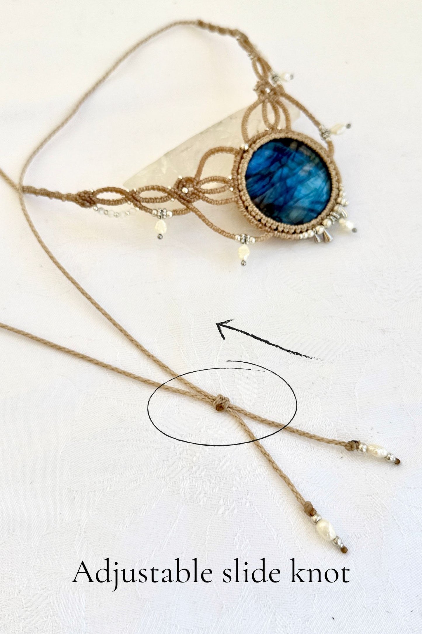 Close-up of adjustable sliding knot on handmade Labradorite macramé necklace for a customizable fit.