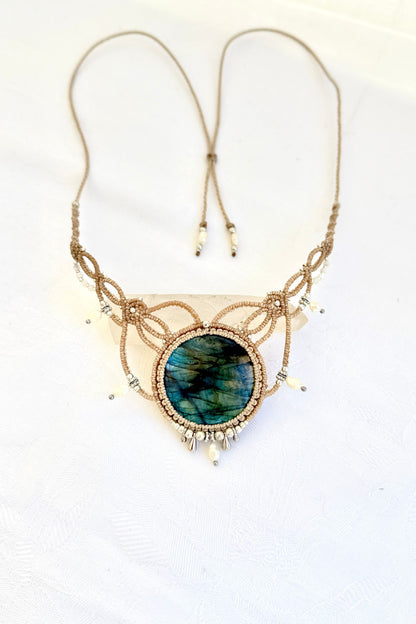 Handmade Labradorite macramé necklace laid flat, featuring freshwater pearl drops, silver beads, and adjustable ends.
