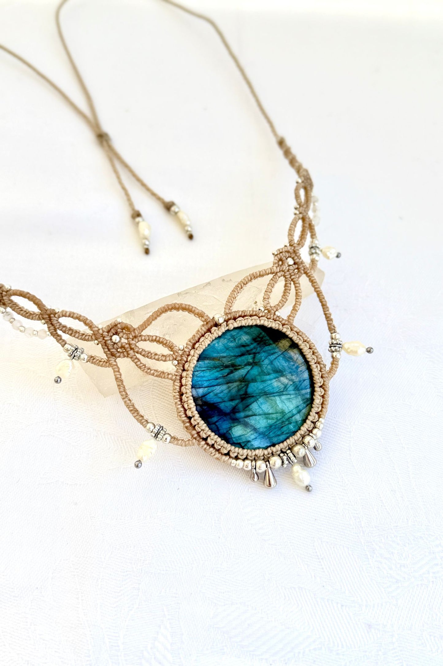 Detailed side view of Labradorite macramé necklace highlighting pearl accents, silver beads, and textured craftsmanship.