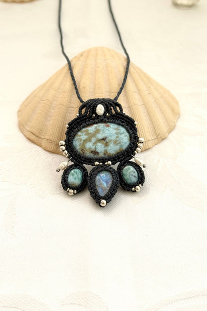 Handmade Larimar and Moonstone macramé necklace laid out, showing balanced gemstone composition and intricate knotwork