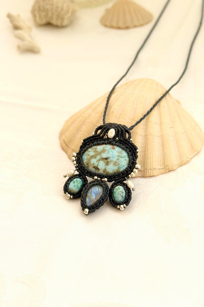 Side view of a Larimar and Moonstone macramé necklace showing layered design, pearl accents, and navy blue cord