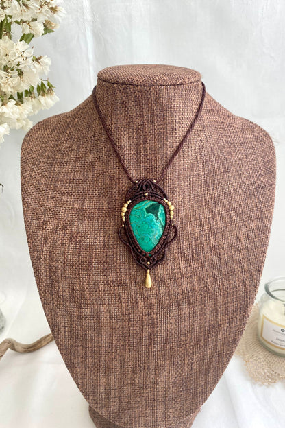Artistic jewelry display of a one-of-a-kind macrame necklace, featuring hand-selected gemstones in a timeless and elegant design.