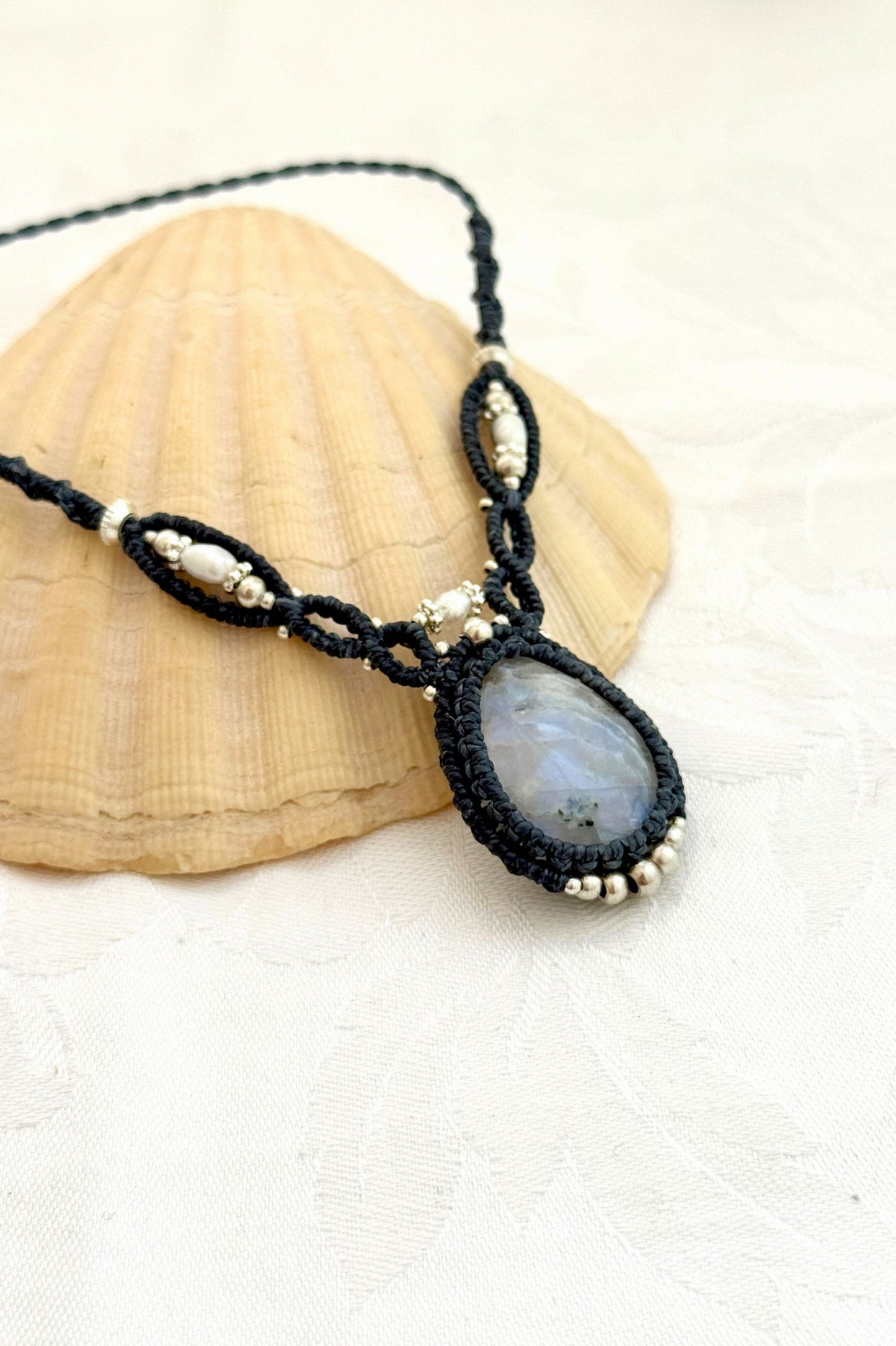 Close-up side view of a Moonstone macramé necklace highlighting Freshwater Pearl accents and intricate knotwork