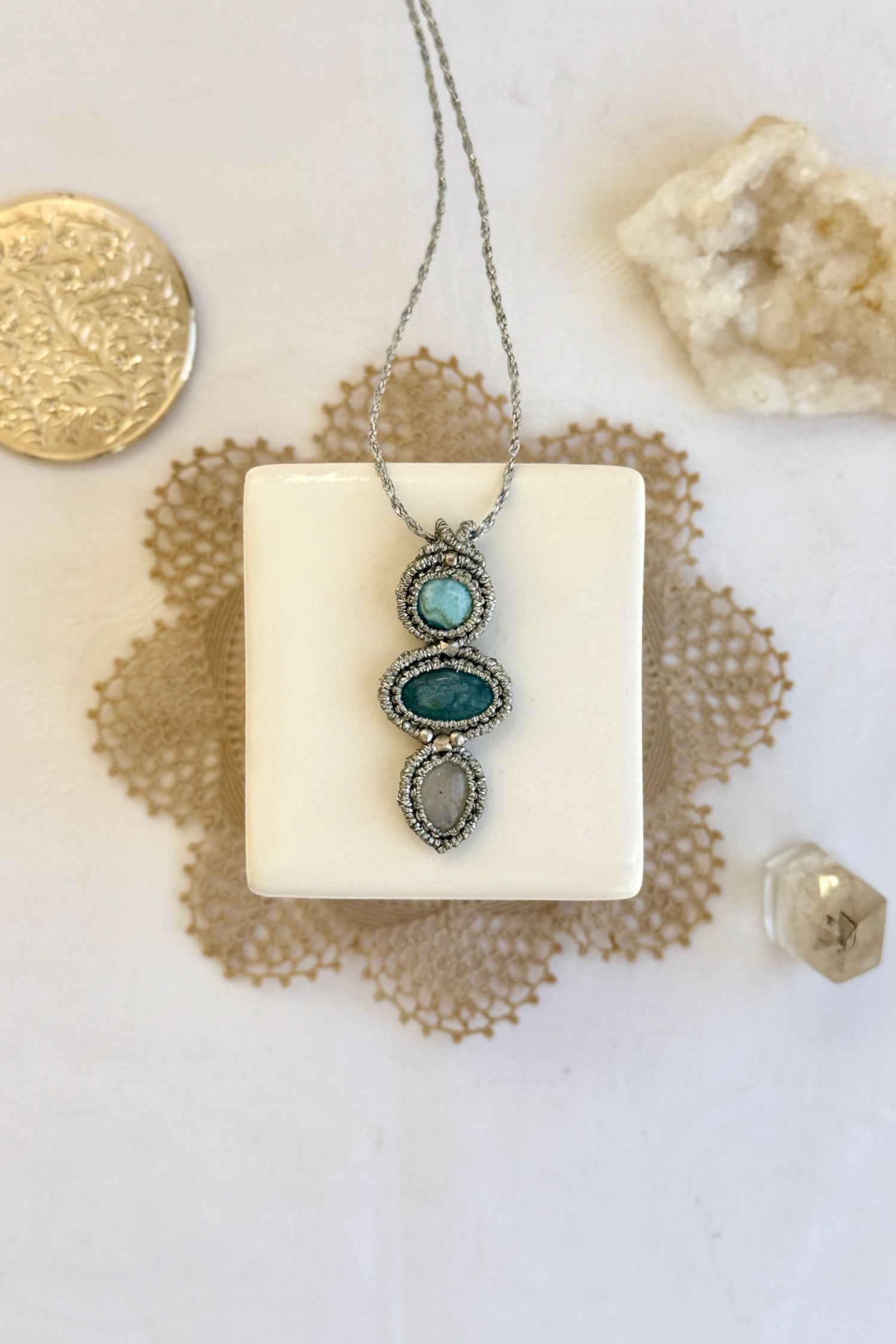 Handmade macrame necklace with Larimar, Aquamarine and Moonstone gemstones. One-of-a-kind design, laid flat for an artistic display.