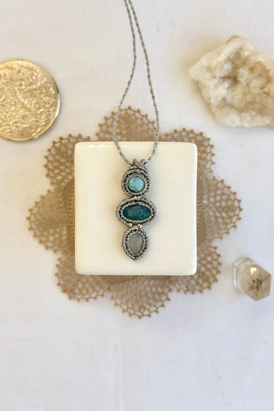 Handmade macrame necklace with Larimar, Aquamarine and Moonstone gemstones. One-of-a-kind design, laid flat for an artistic display.