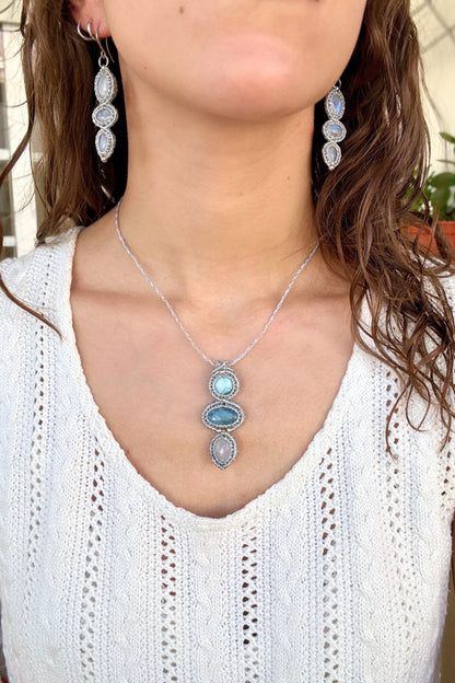 Larimar, Aquamarine and Moonstone macrame necklace worn by a model. Showcasing the unique handmade design and how it looks when worn.