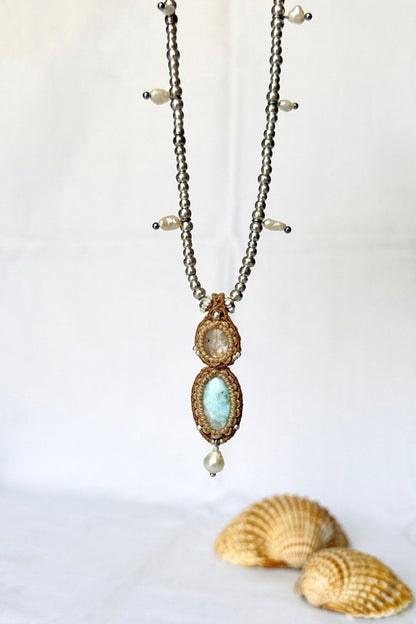 Hanging Moonstone and Larimar necklace with freshwater pearl accents and a pearl drop beneath the pendant.