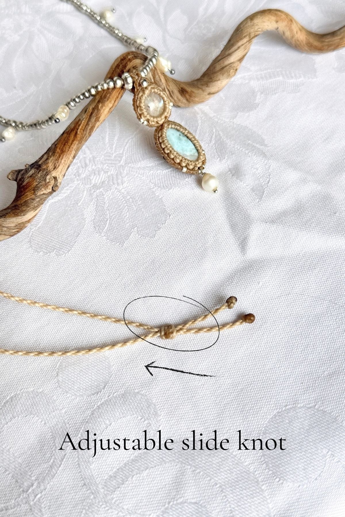 Adjustable sliding knot on the macrame necklace cord, circled with an arrow to show the length adjustment.