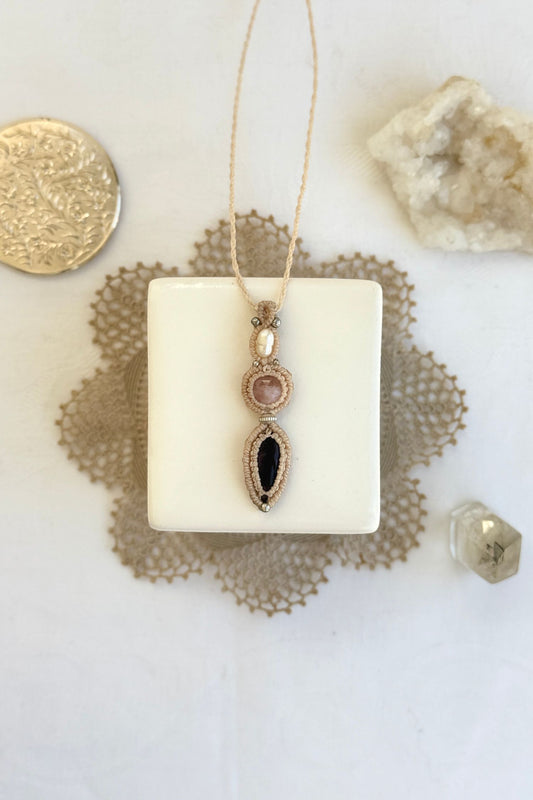 Handmade macrame necklace with Freshwater Pearl, Rose Quartz and Amethyst gemstones. One-of-a-kind design, laid flat for an artistic display.