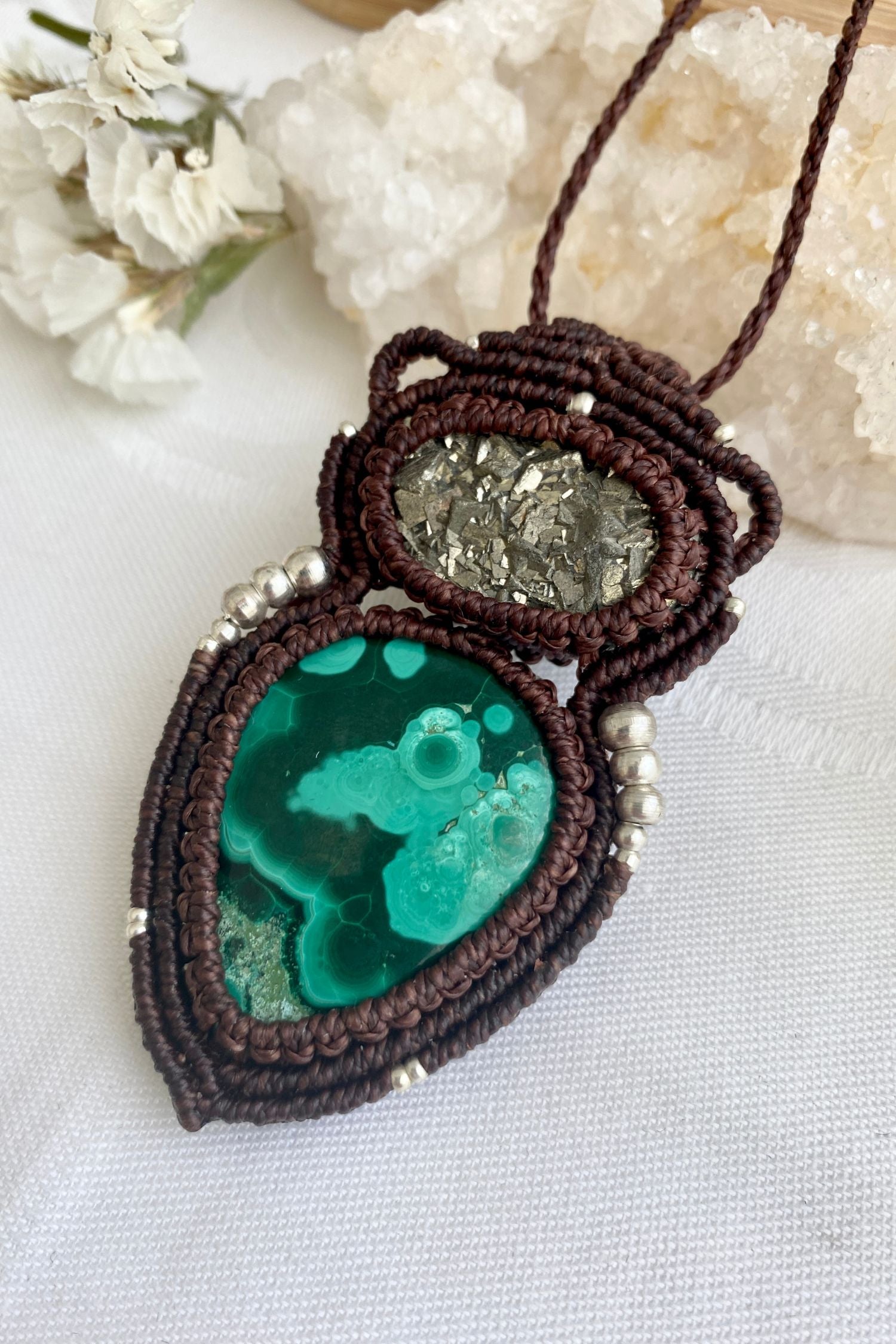 Side view of handmade macrame necklace featuring malachite gemstone with raw pyrite, showcasing the detailed macrame knots.