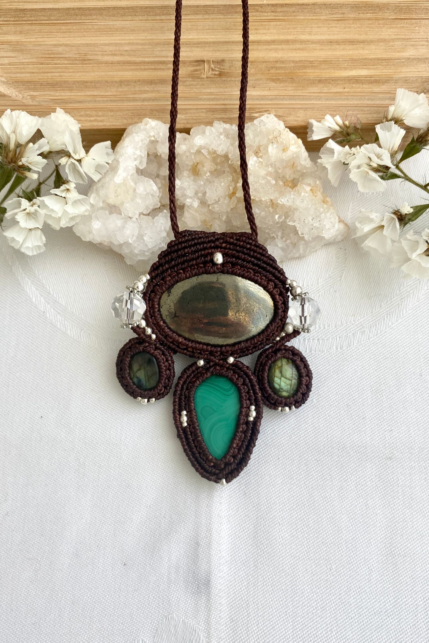 A close-up of the handmade gemstone necklace, showcasing the natural beauty of Pyrite, Labradorite, Malachite and Quartz in an exclusive, one-of-a-kind design.