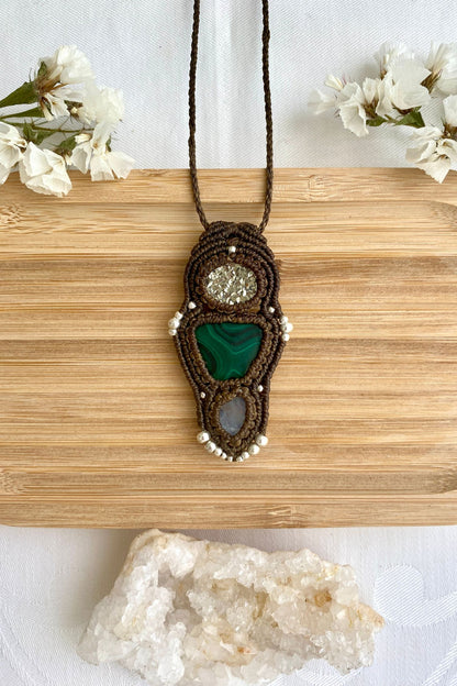 Handmade macrame necklace featuring  Raw Pyrite, Malachite and Moonstone gemstones, crafted with a unique and artistic design, offering an adjustable length for a perfect fit.