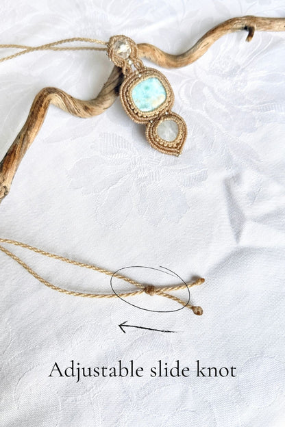 Adjustable sliding knot on the pendant’s cord, circled with an arrow showing where to adjust the necklace length.