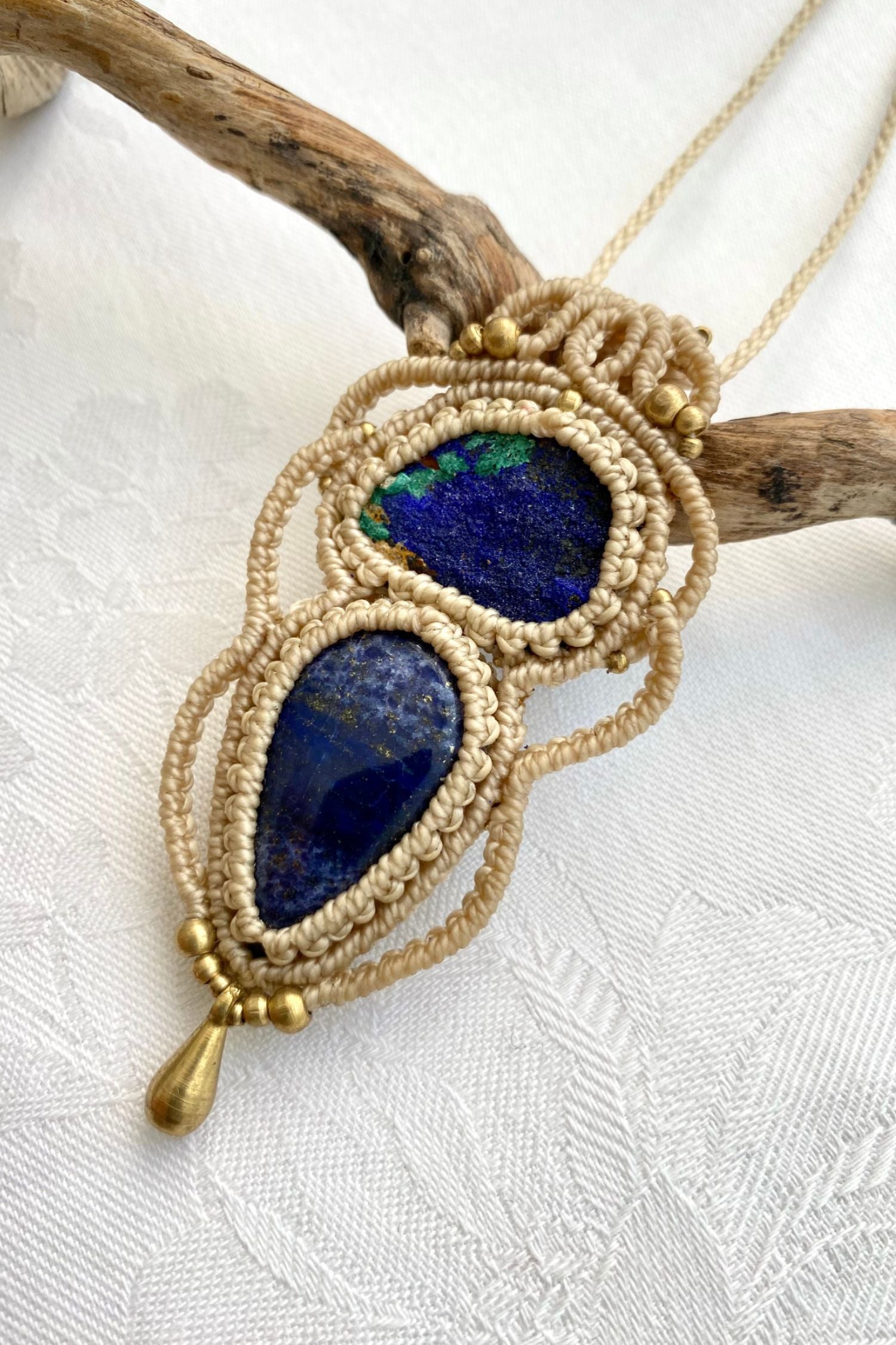 Side angle of the handcrafted macrame necklace, highlighting the detailed craftsmanship and the rich colors of Raw Azurite and Lapis Lazuli gemstones.