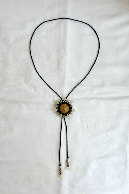 Sea urchin fossil bolo tie necklace with sun-inspired prehnite halo and rutilated quartz details, sculptural artisan jewelry