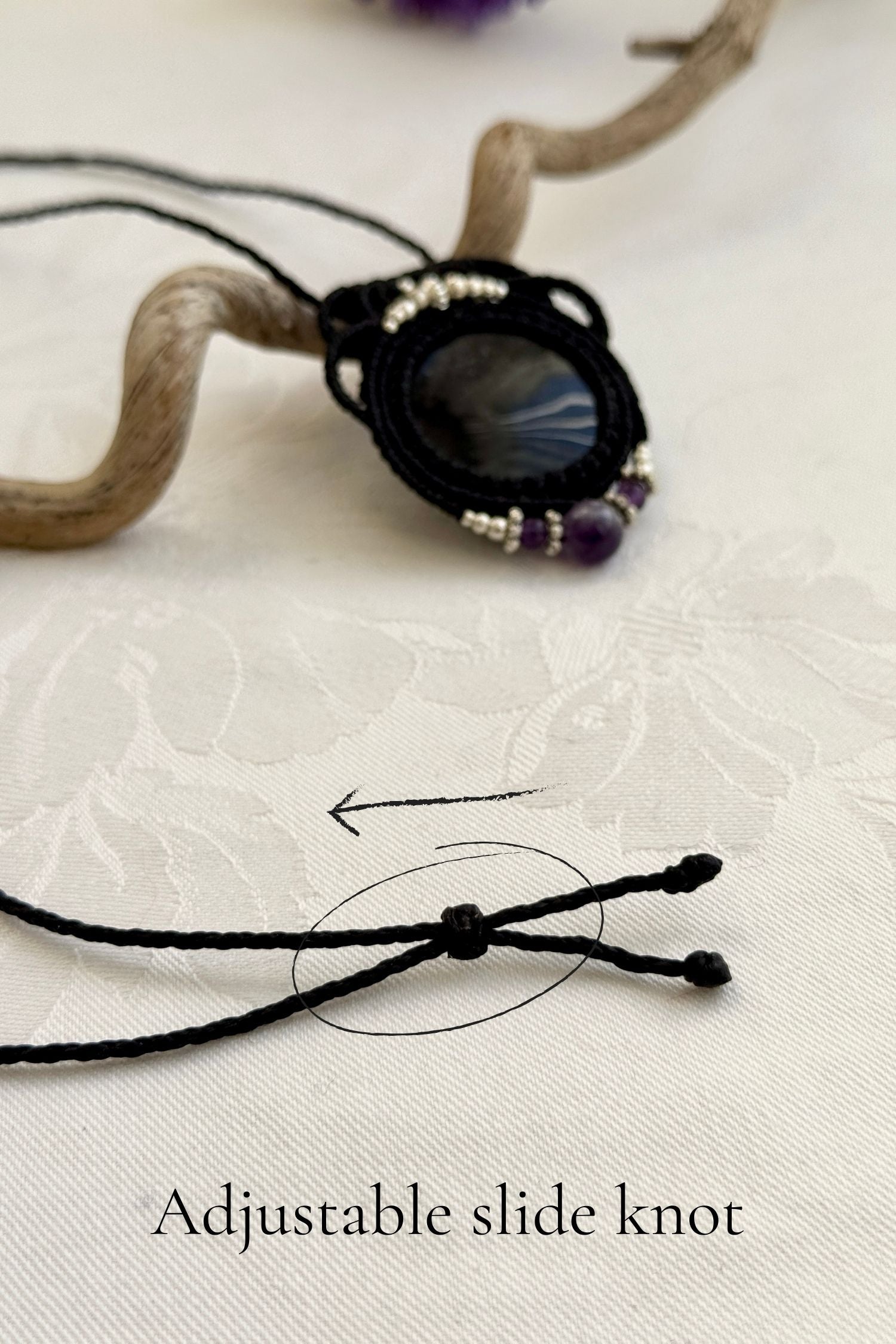 Adjustable handmade macrame necklace with Silver Sheen Obsidian and Amethyst. Featuring a sliding knot closure for a customizable fit.