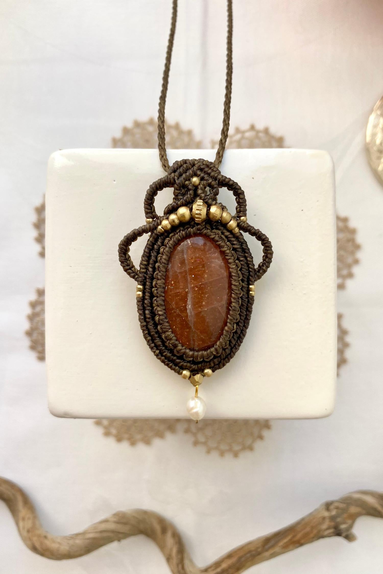 Handmade macrame necklace featuring a natural Sunstone gemstone and Pearl, crafted with a unique and artistic design, offering an adjustable length for a perfect fit.