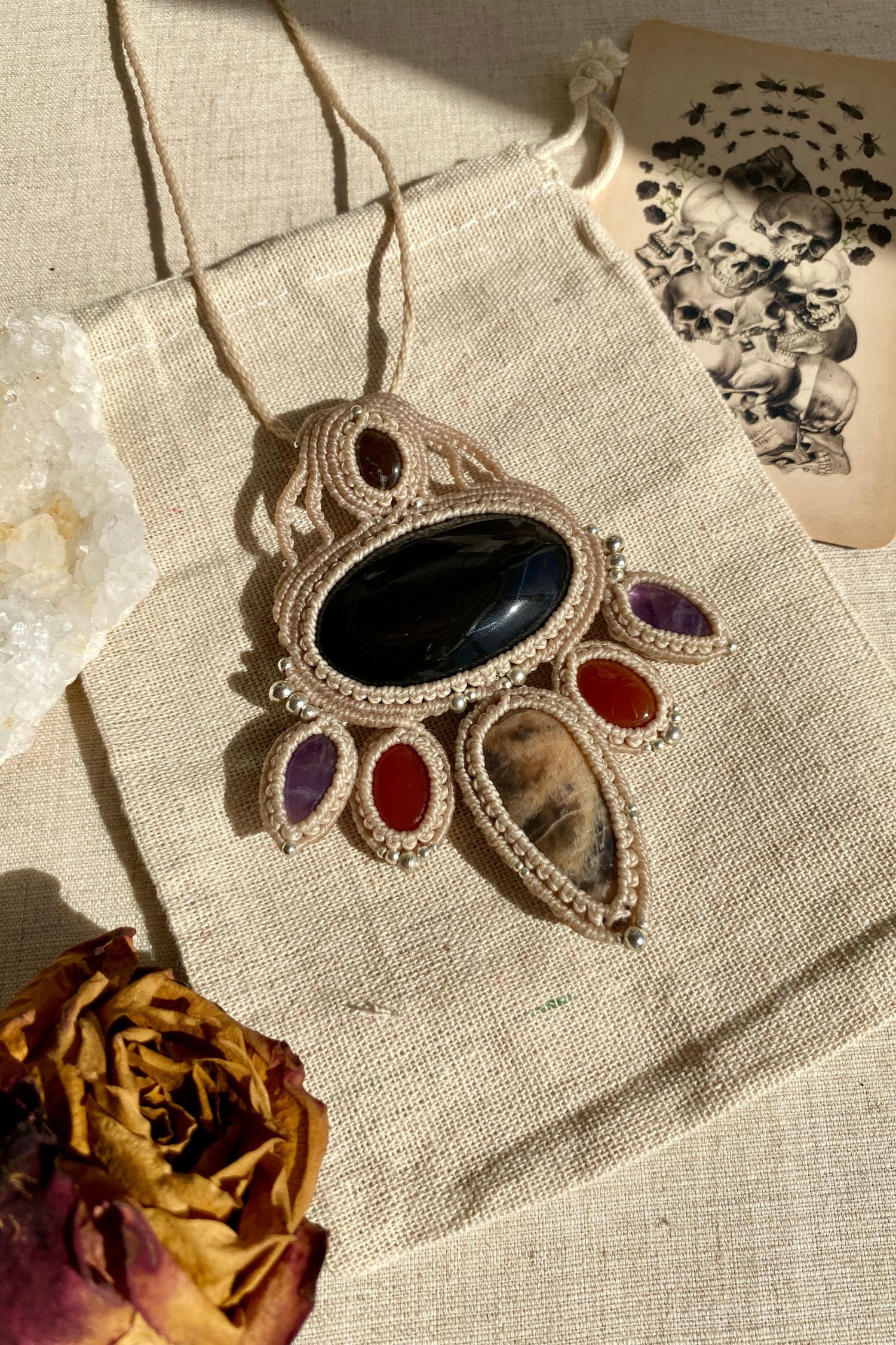 Handmade multi-gemstone macrame necklace featuring Obsidian, black moonstone, smoky quartz, carnelian, and amethyst, blending elegance and bold design.