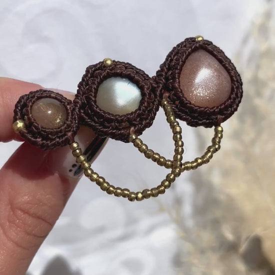Close-up video of the handmade statement brooch, capturing the shimmer of the three Peach Moonstone gemstones and the intricate details of the design.