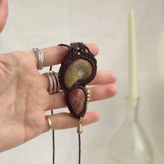 Opalized ammonite pendant necklace showing iridescent fossil tones and natural sparkle of sunstone, highlighting dangling movement