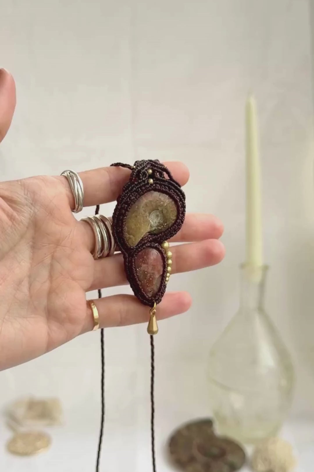 Opalized ammonite pendant necklace showing iridescent fossil tones and natural sparkle of sunstone, highlighting dangling movement